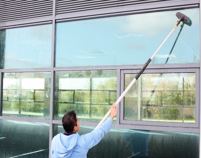 A worker from A Clear View Window Cleaning is cleaning windows during the fall in Stewartstown, PA